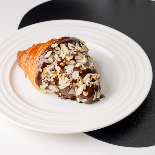 Croissant with dark chocolate and almond flakes