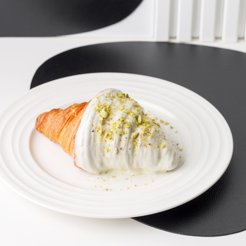 Croissant with white chocolate glaze and pistachio